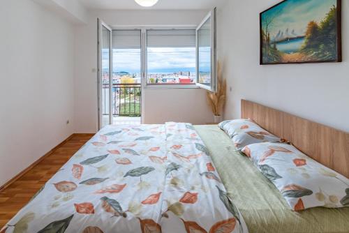 a bedroom with a bed with a view of a window at Charming & Spacious 2 Bedroom Apartment with a Gorgeous 8th-floor view in Ohrid