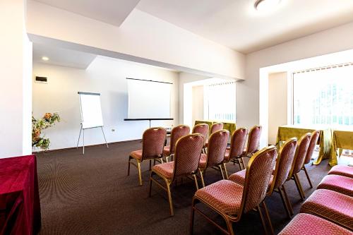 a conference room with chairs and a projection screen at Primoretz Grand Hotel & Spa in Burgas City