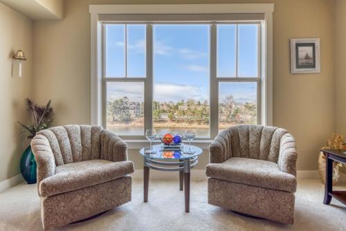 two chairs and a table in a room with a window at Rivers Edge at Bridgeport in Seaside