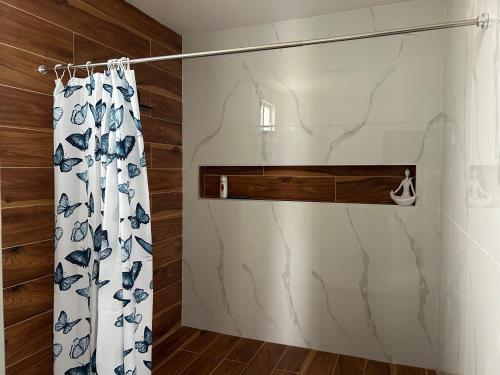 einem Duschvorhang mit blauem und weißem Muster in der Unterkunft Mar de Calafia 1 in Divisadero