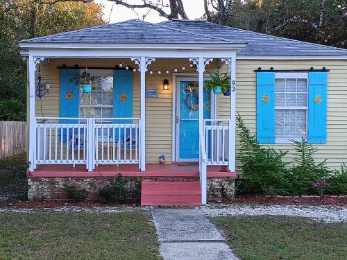 a small house with blue doors and a porch at The Lemon Zest Cottage Paws Welcome in Pensacola
