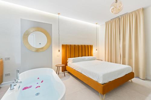 a bedroom with a bed and a bath tub at Sofì Luxury Suite in Iglesias