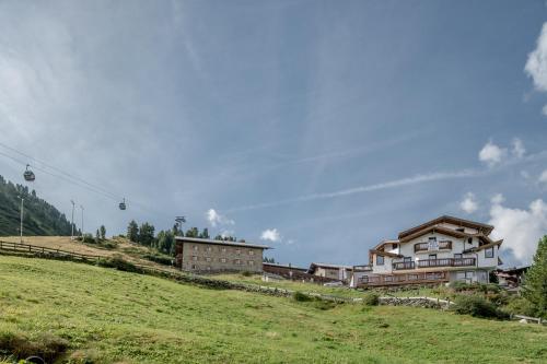 a group of buildings on top of a hill at Das Hochegg - Apartments in Obergurgl