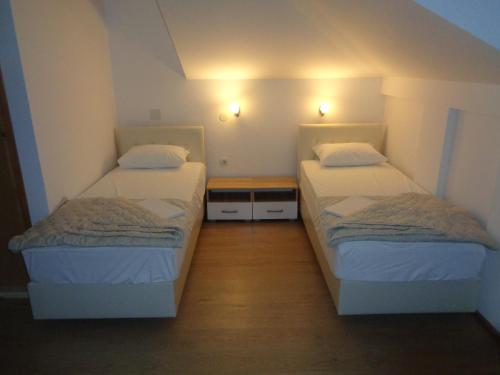 a room with two beds in a room with lights at Villa Boka Sunrise Apartments in Herceg-Novi