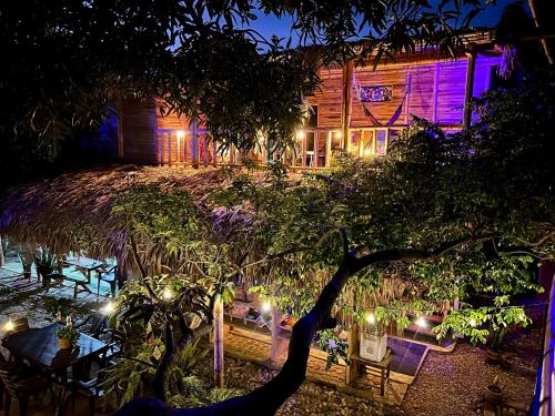 a night view of a house with lights at Hostal Corazón de Tagua in Palomino