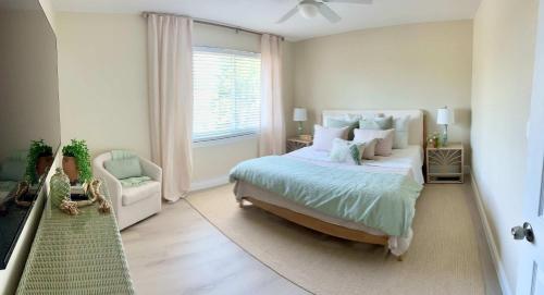 a bedroom with a large bed and a window at Coastal Countdown Relaxed Townhome Near Beach and Rockets in Cape Canaveral