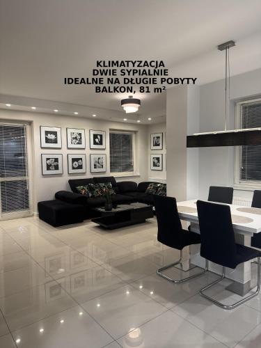 a living room with a couch and a table and chairs at Spanko w centrum in Zielona Góra