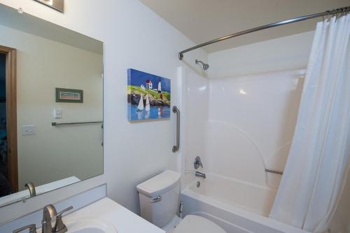 a bathroom with a sink and a toilet and a shower at Family Tides in Seaside in Seaside