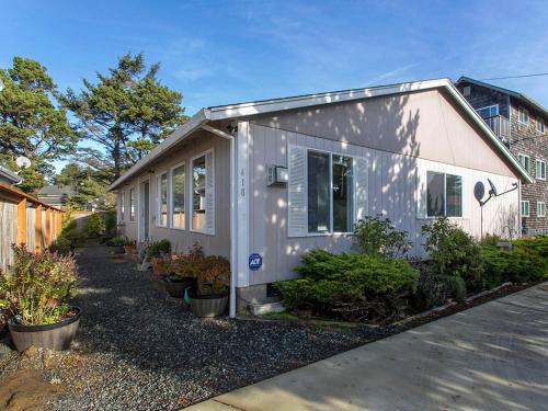 a tiny house is parked in a yard at Family Tides in Seaside in Seaside