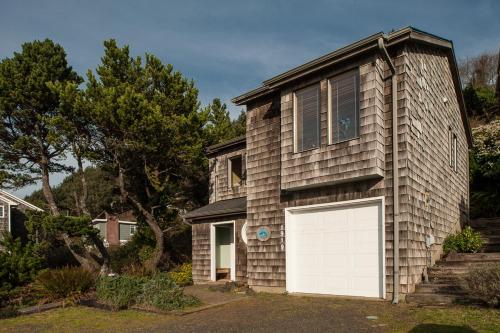 a house with a white garage door on it at Calypso in Lincoln City