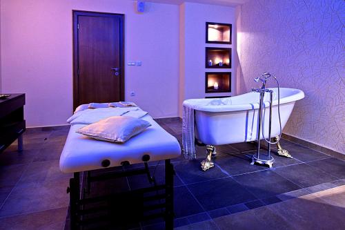 a large bathroom with a tub and a sink at Primoretz Grand Hotel & Spa in Burgas City