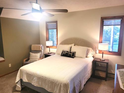 a bedroom with a bed and a ceiling fan at New! Crystal Pines - Lovely Crystal Mountain Cabin in Thompsonville