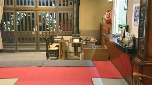 a dining room with a table and chairs and a christmas tree at 天狗の茶屋旅館 in Miyota