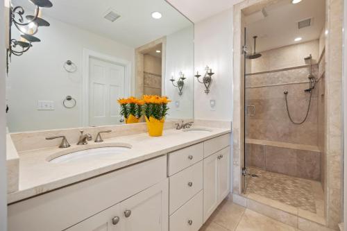 a white bathroom with two sinks and a shower at SS3559: 3559 Seascape in Kiawah Island