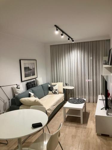 a living room with a couch and a table at Arminda in Arguineguín
