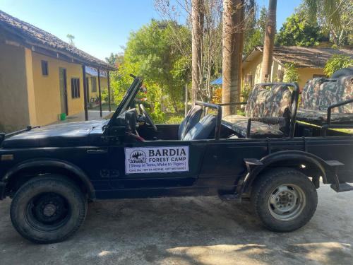 a black truck parked in front of a house at Bardia Forest Camp in Bardia