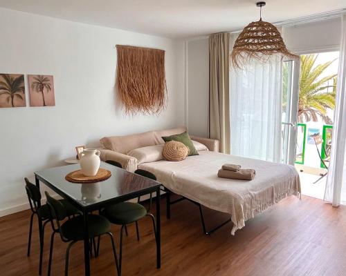 a living room with a bed and a table at Anahata Homes in Antigua