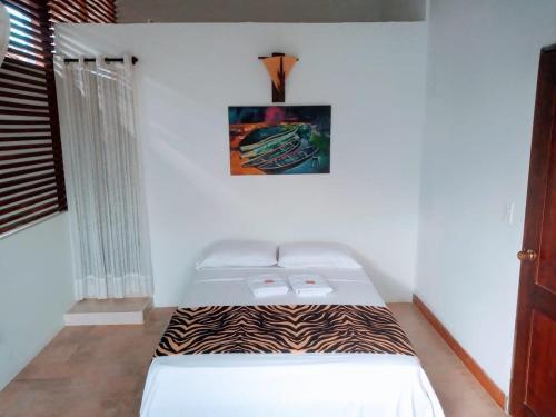 Ένα ή περισσότερα κρεβάτια σε δωμάτιο στο Guacamayas del Mar