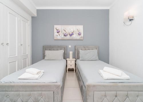 two twin beds in a room with white walls at 403 - Oura - 2 bedroom- Sea View in Albufeira