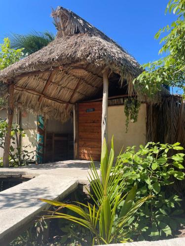 a small hut with a straw roof at Casa Balam Sisal in Sisal