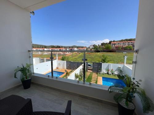 a balcony with a view of a swimming pool at Chalet villa QUE POUR LES FAMILLES in Imouzzer du Kandar