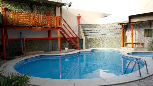 a large swimming pool in front of a building at Hotel Arena Caliente in Playas