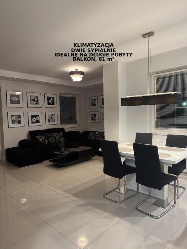 a living room with a couch and a table and chairs at Spanko w centrum in Zielona Góra