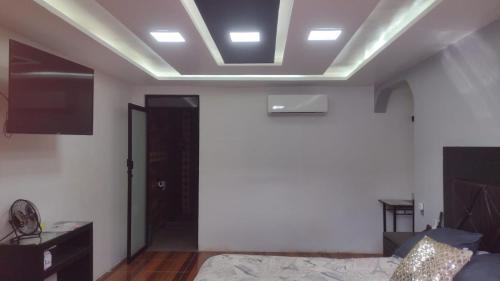 a room with a bed and a ceiling with lights at Apartamento mandarina in Zacatecas