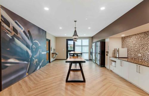 a kitchen with a table in the middle of a room at Extended Stay America Premier Suites - Jacksonville - Airport in Jacksonville