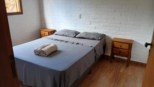 Ένα ή περισσότερα κρεβάτια σε δωμάτιο στο Chalé cachorrinha