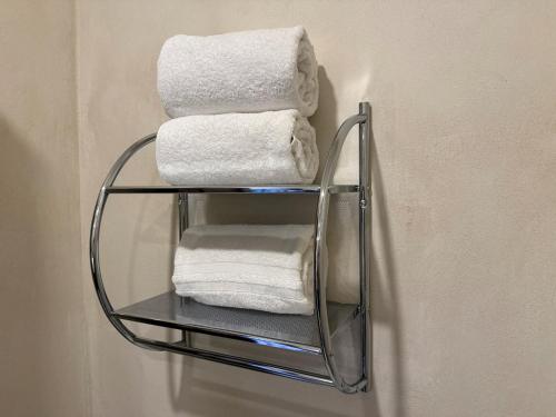 a stack of towels on a shelf in a bathroom at Firenze en ValQuirico in Santeagueda