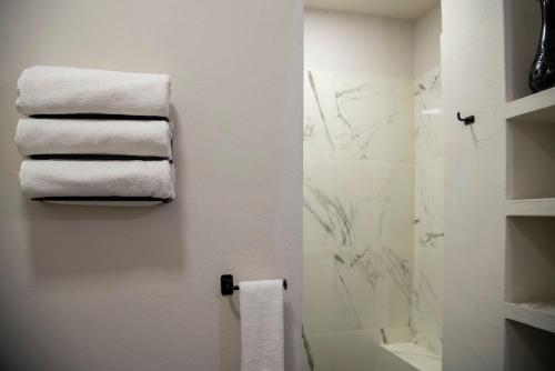 a bathroom with white towels on a wall at Hotel MariaBonita San Miguel de Allende in San Miguel de Allende