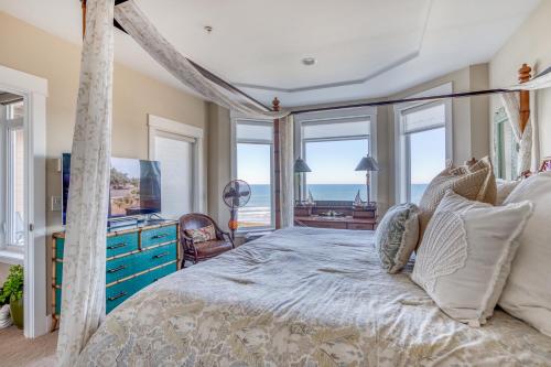 a bedroom with a bed with a view of the ocean at Sunsets at the Shoreline in Newport