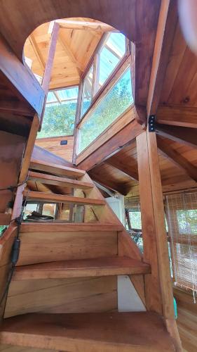 a set of wooden stairs in a house at Octógono Soñado Lodge in El Boquerón
