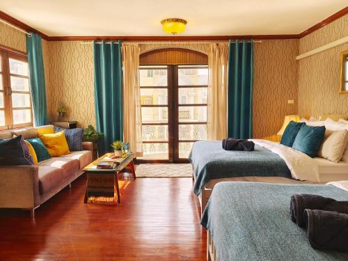 a living room with two beds and a couch at Danita's Home Bangkok in Bangkok