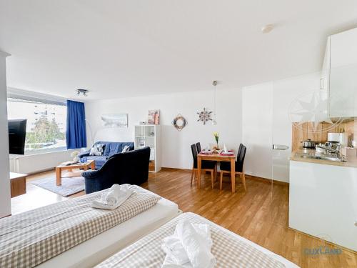 a living room with two beds and a dining room at Lord Nelson Wohnung 118 in Döse