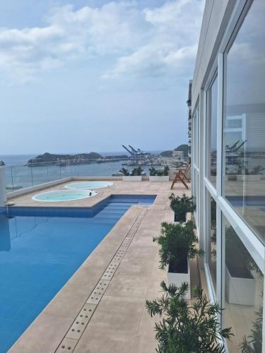 a view of a swimming pool from the balcony of a house at Nuevo Apartaestudio en frente de la marina in Santa Marta