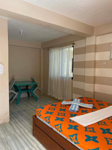 Ένα ή περισσότερα κρεβάτια σε δωμάτιο στο Daddy Capts Guesthouse Bantayan Island