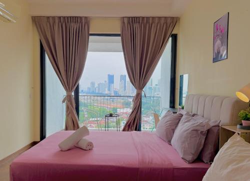 a bedroom with a pink bed with a large window at Landmark Seaview Cozy Family Suite with Balcony 6 Pax in Tanjong Tokong
