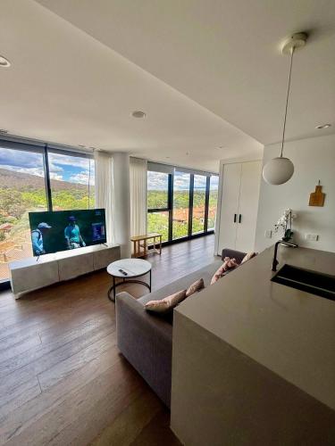 a living room with a couch and a flat screen tv at 2BR-2BR-2Cars -CBD-Pool-sleeps 6 in Canberra