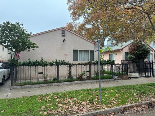 a house with a fence in front of a house at 2 bedrooms in downtown easy parking in Sacramento