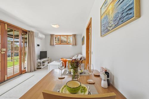 a kitchen with a table and a dining room at Otago Cottage in Hobart