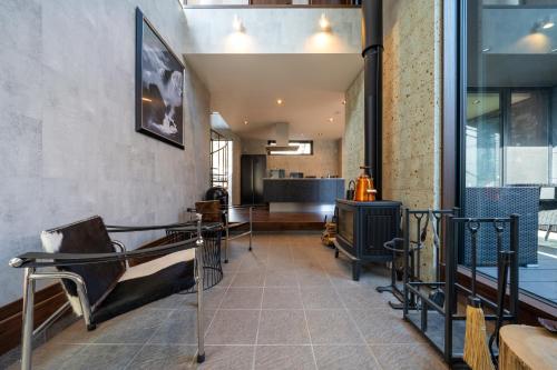 a living room with a couch and a television at RIVER VIEW HOUSE-Sauna- in Nasushiobara