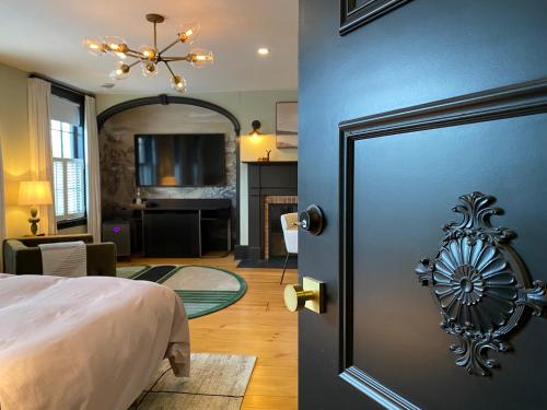 a bedroom with a door leading to a living room at Hattan House Boutique Hotel Bed & Breakfast in Niagara on the Lake