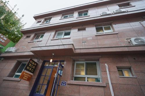 a brown brick building with windows and a door at SeoulView Guest House in Seoul
