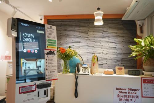 a room with a counter with a phone and a wall at SeoulView Guest House in Seoul