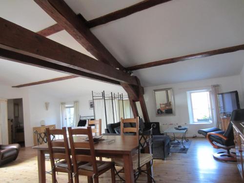 a living room with a wooden table and chairs at Chez Shona in Lagrasse