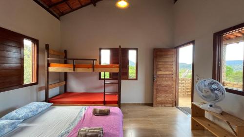 En eller flere senge i et værelse på Casa Mirante dos Muricis Vale do Capão