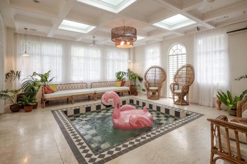 a pool with a pink swan in the middle of a living room at MIRANAMIN NEST Elegant Home, Indoor Plunge Pool, Pet-Friendly, with Rooftop, Kitchens, Self-Service Breakfast - Ideal for Reunions, Team Building, Intimate Gatherings in Manila