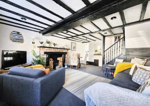 a living room with a couch and a fireplace at Leaf Tree Cottage, close to Coast, Lakes and Fells in Workington